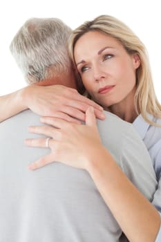 Close up of mature couple embracing over white background
