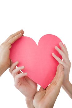 Close up of hands holding heart over white background