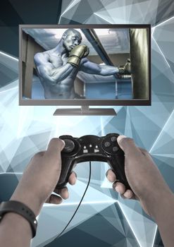 Digital composite of Hands holding gaming controller  with boxer fighter on television