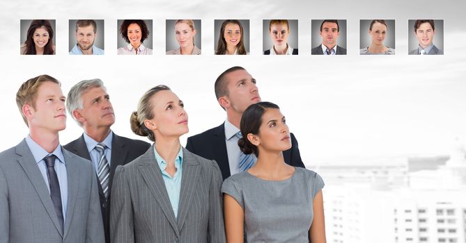 Digital composite of Business people looking up at portrait profiles of different people
