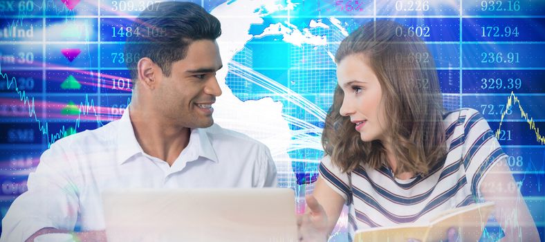 Business people discussing while sitting at table against stocks and shares