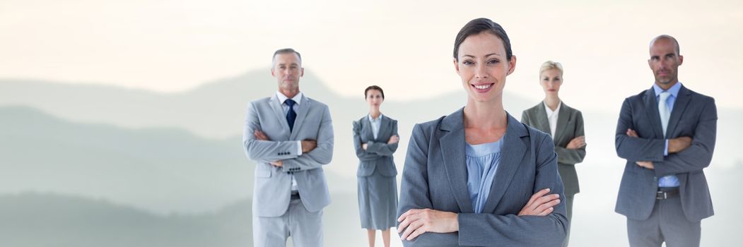 Digital composite of Business people and mountain landscape with flare light source