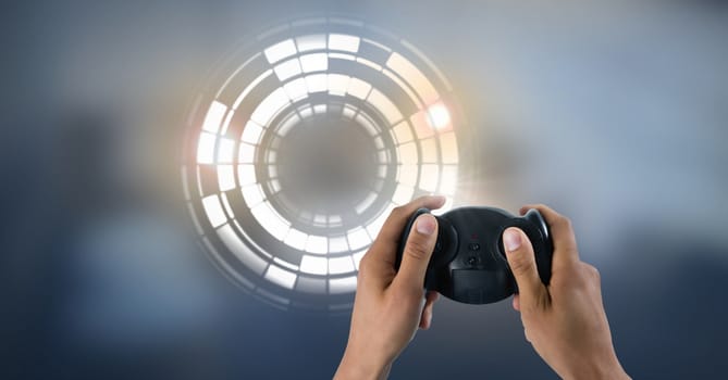 Digital composite of Hands with game controller and Glowing circle technology interface