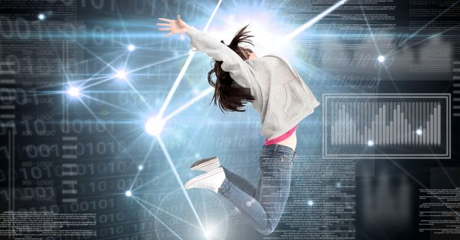 Digital composite of Woman jumping expressively with digital technology interface