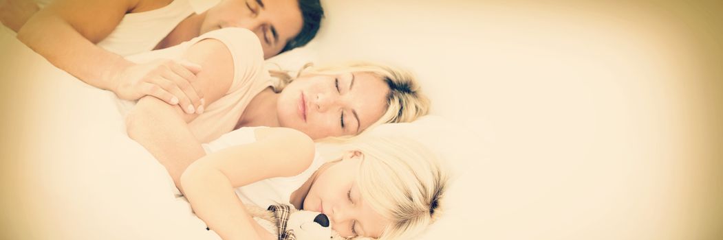 Family sleeping together on a same bed