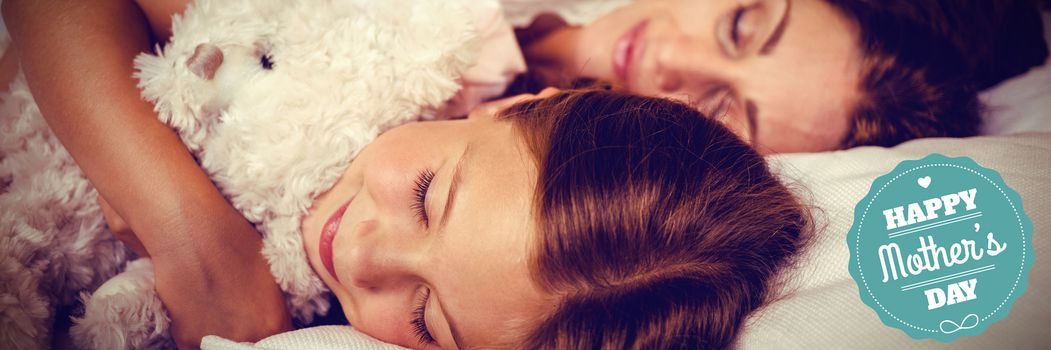 mothers day greeting against high angle view of family sleeping on bed