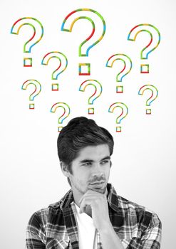 Digital composite of Man thinking with colorful question marks