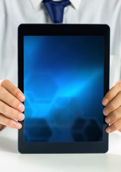 Digital composite of hands holding tablet with gradient screen