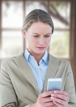Digital composite of Woman using phone by window
