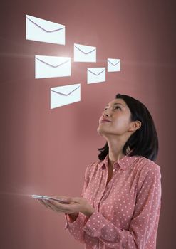 Digital composite of Envelope letter messages and woman using tablet