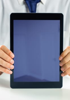 Digital composite of Holding blank screen tablet with businessman