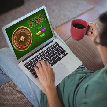 Online Roulette Game  against man using laptop in living room