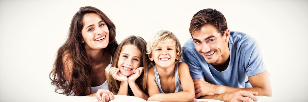 Happy family lying on a bed together in the bedroom