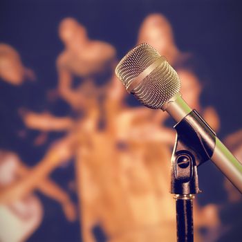 Close-up of microphone  against portrait of happy friends toasting at table