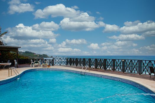 A blue swimming pool on the coast of a tropical island