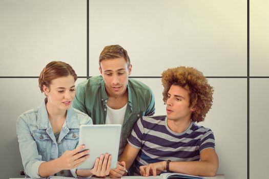 Fashion students using tablet  against white tiling