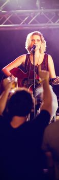 Female performer singing during music event at nightclub