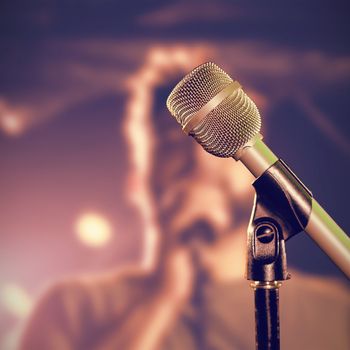 Close-up of microphone  against male singer performing at nightclub