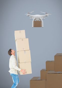 Digital composite of Man lifting delivery parcels stacked up to drone flying