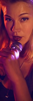 Close up portrait of singer performing with female drummer in nightclub