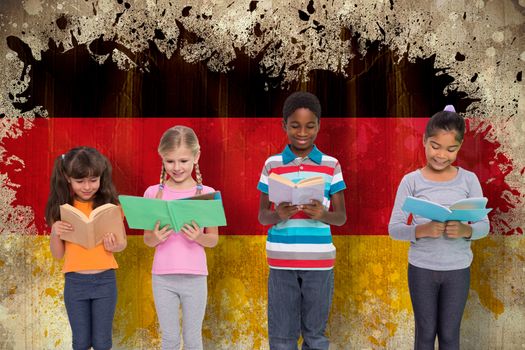 Elementary pupils reading against germany flag in grunge effect