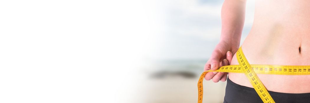 Digital composite of Woman measuring weight with measuring tape on waist on Summer beach with transition