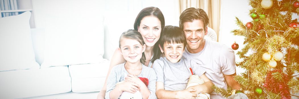 Young family having fun with christmas presents at home