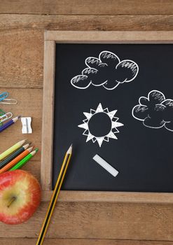 Digital composite of Clouds and sun Education drawing on blackboard for school