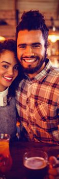 Portrait of couple embracing each other in pub