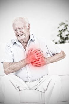 Aged man suffering with heart pain against highlighted pain