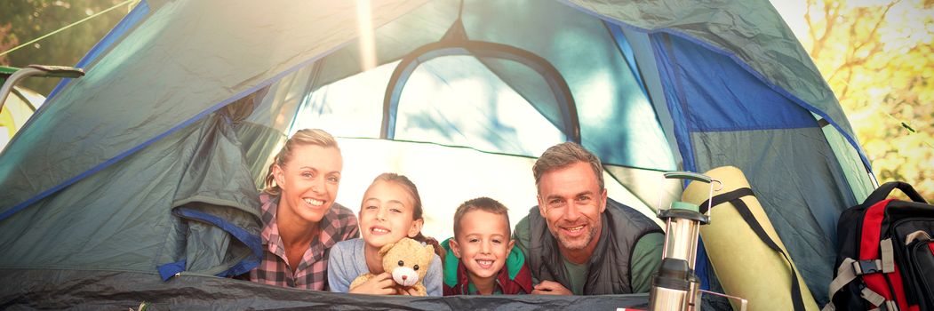 Portrait of smiling family lying in the tent