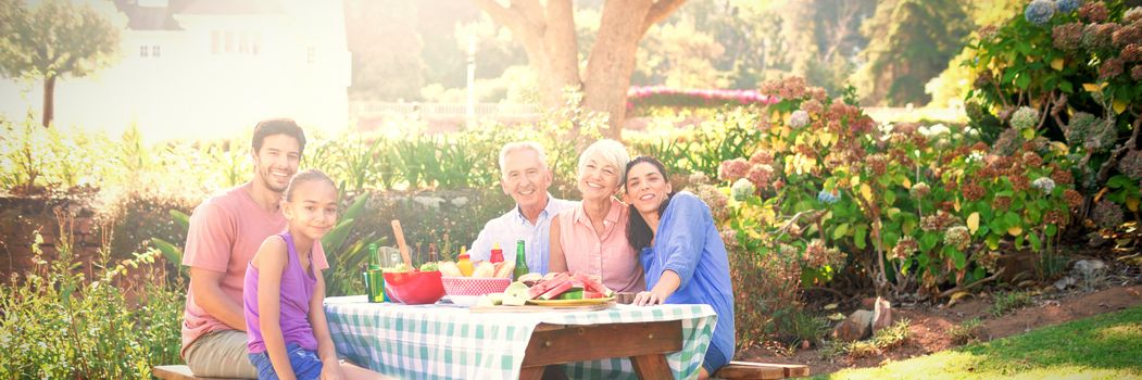 Portrait of happy family having barbecue in the park