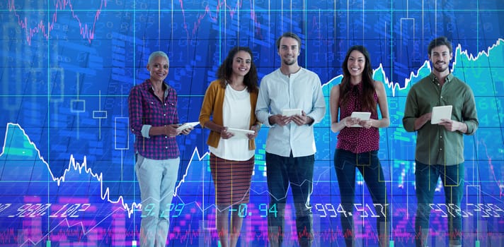 Portrait of confident business people holding tablet computers against stocks and shares