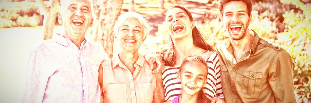 Portrait of happy family standing together in the park