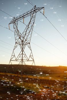 Screen with times against the evening electricity pylon silhouette