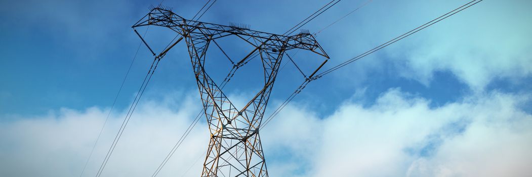 Blue sky with clouds against the evening electricity pylon silhouette