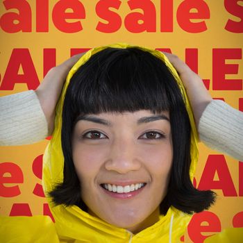 Woman wearing yellow raincoat against white background against orange background