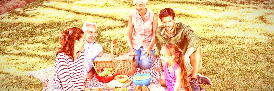 Happy family having picnic in the park on a sunny day