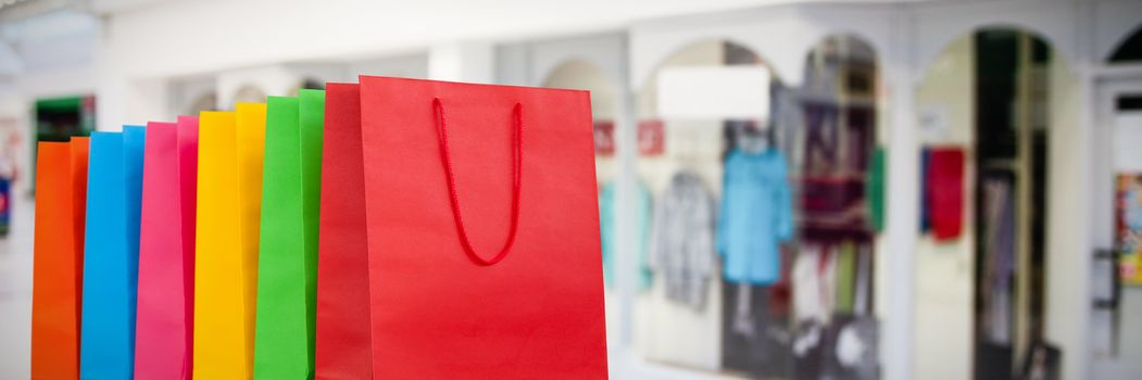 Shopping bags against interior of modern shopping mall