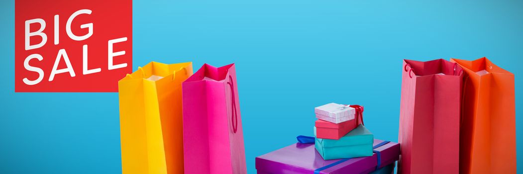 Shopping bags against plain blue background