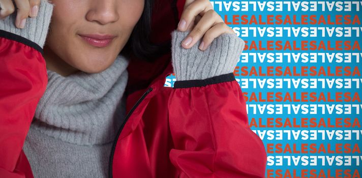 Smiling woman in hooded jacket standing against white background against blue background