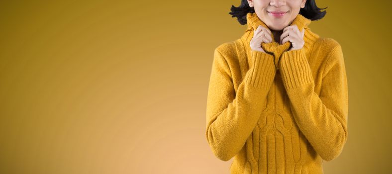 Woman in winter clothing posing against white background against abstract blue background