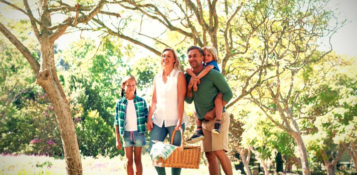 Family arriving in the park for picnic on a sunny day