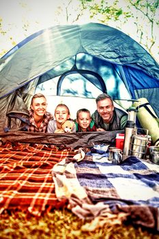 Portrait of smiling family lying in the tent