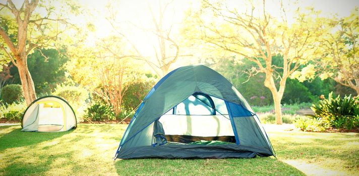 Two tents at campsite on a sunny day
