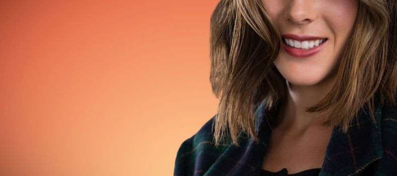 Close up portrait of young woman with brown hair against abstract yellow background