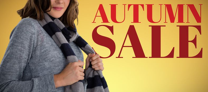 Portrait of young woman in scarf against abstract yellow background