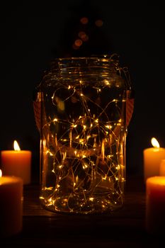 electric garland in a glass jar with candles