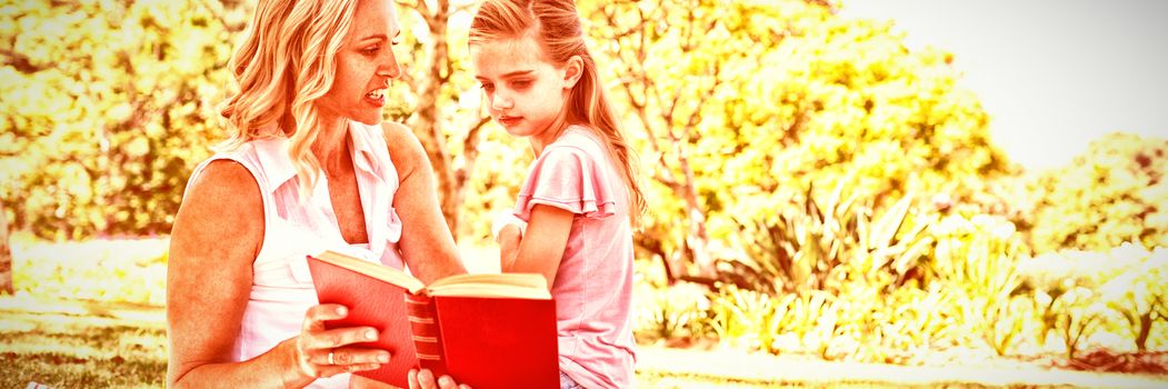Mother and daughter reading novel in park on a sunny day