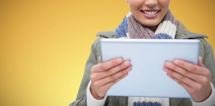 Composite image of  women holding tablet against abstract yellow background